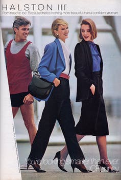 A man looks at two stylishly dressed women walking by.