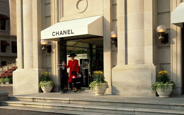 A woman in a red suit leaves Chanel.