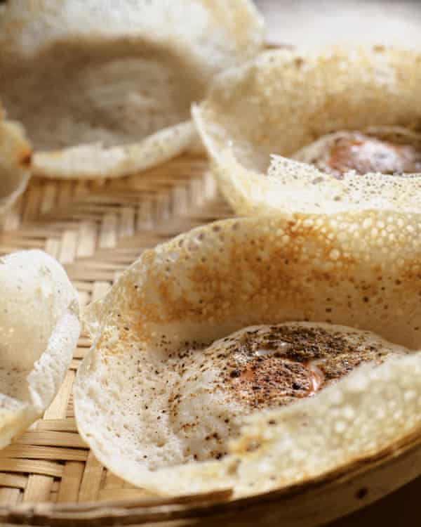 To make egg hoppers, crack an egg into a bowl and pour it into the batter as soon as you have swirled it.