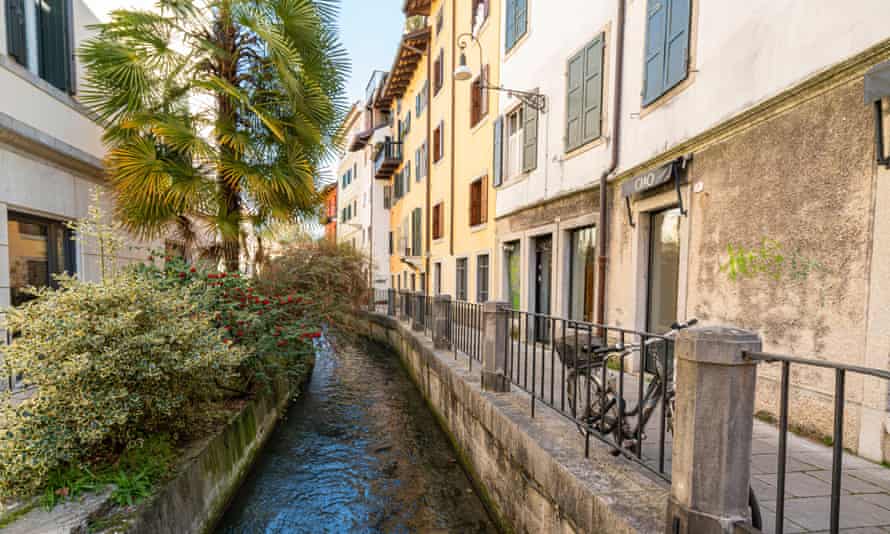 The old canal between houses in the city centre, Udine, Italy.