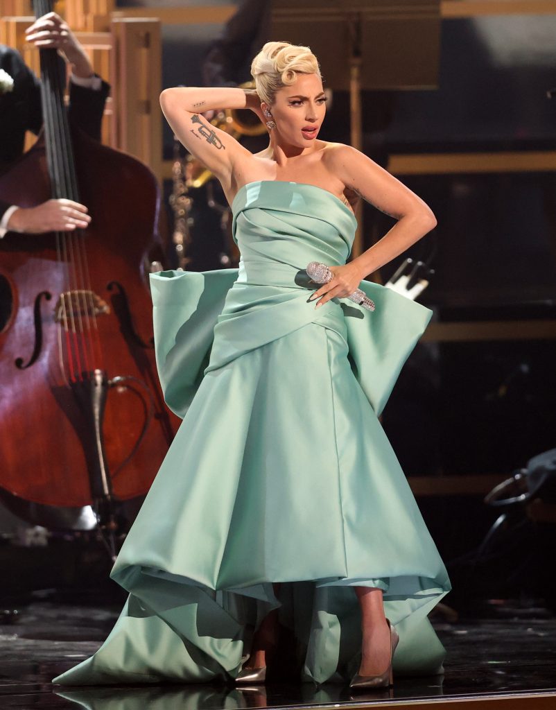 Lady Gaga, Grammy Awards, performance, jazz performance, Tony Bennett, red carpet, pumps, gold pumps, metallic pumps, stiletto pumps, dress, bow dress, green dress, silk dress, Tiffany & Co., diamond earrings, stud earrings