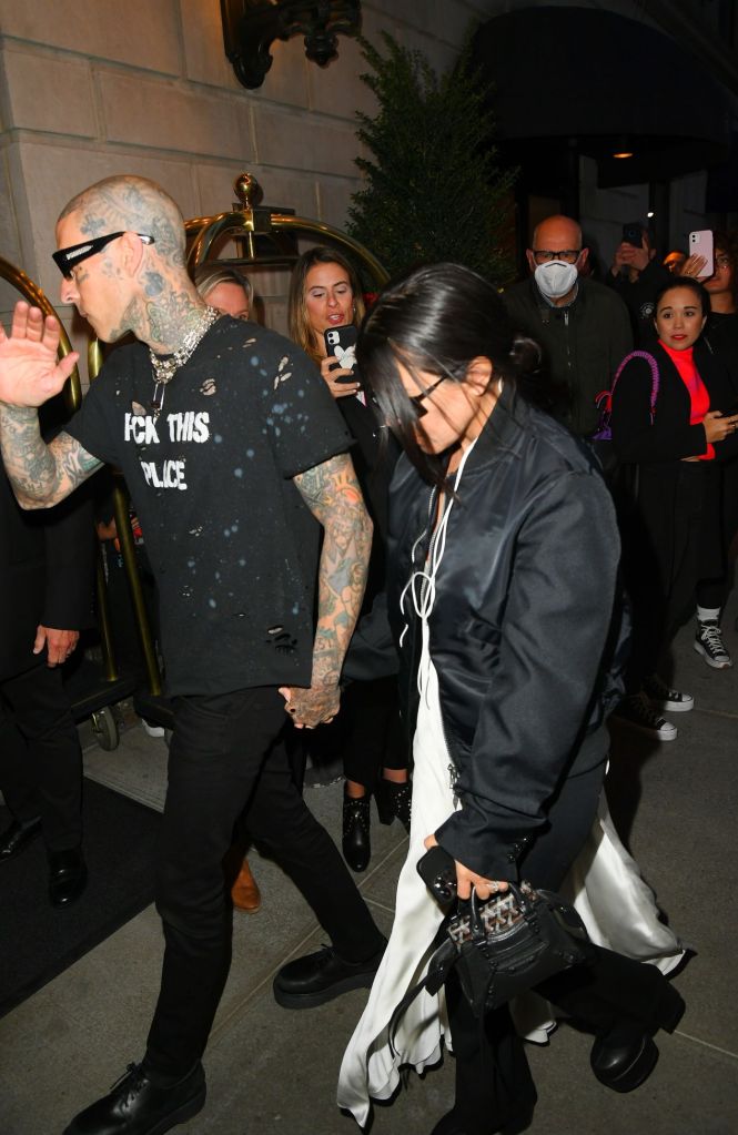 Kourtney Kardashian and Travis Barker hold hands as they arrive to the Ritz Hotel.