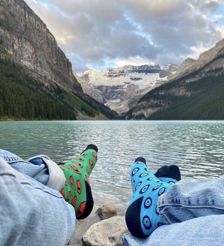 Colorful socks on feet in front of mountains 