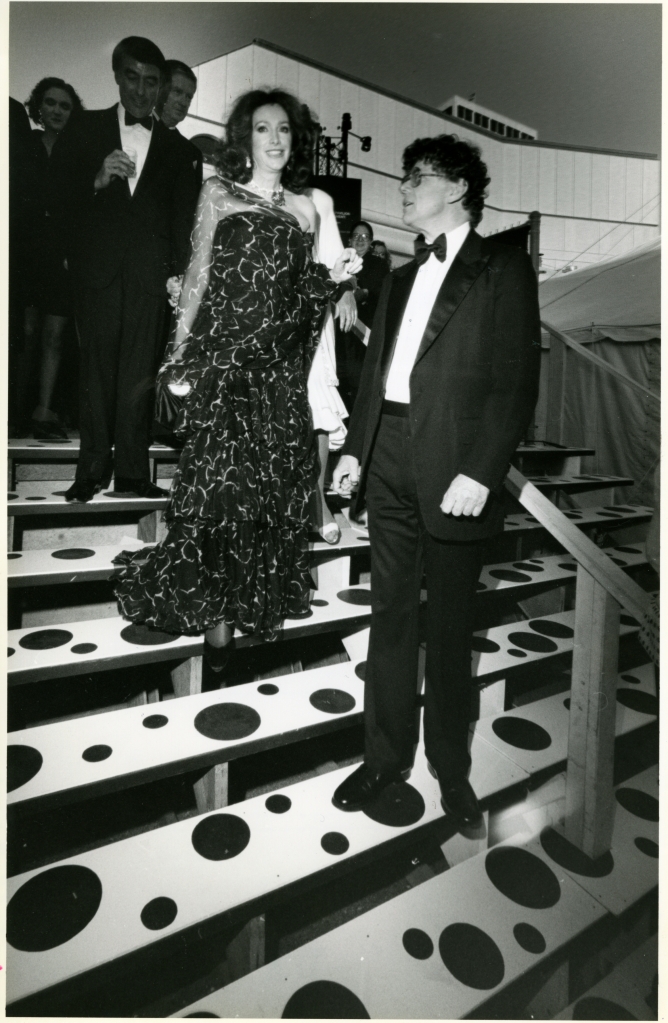Ann and Gordon Getty descend the steps at the Patron's Dinner for the 1991 Black and White Ball. Ann is wearing one of the pansy earrings as a brooch on her black gown. 