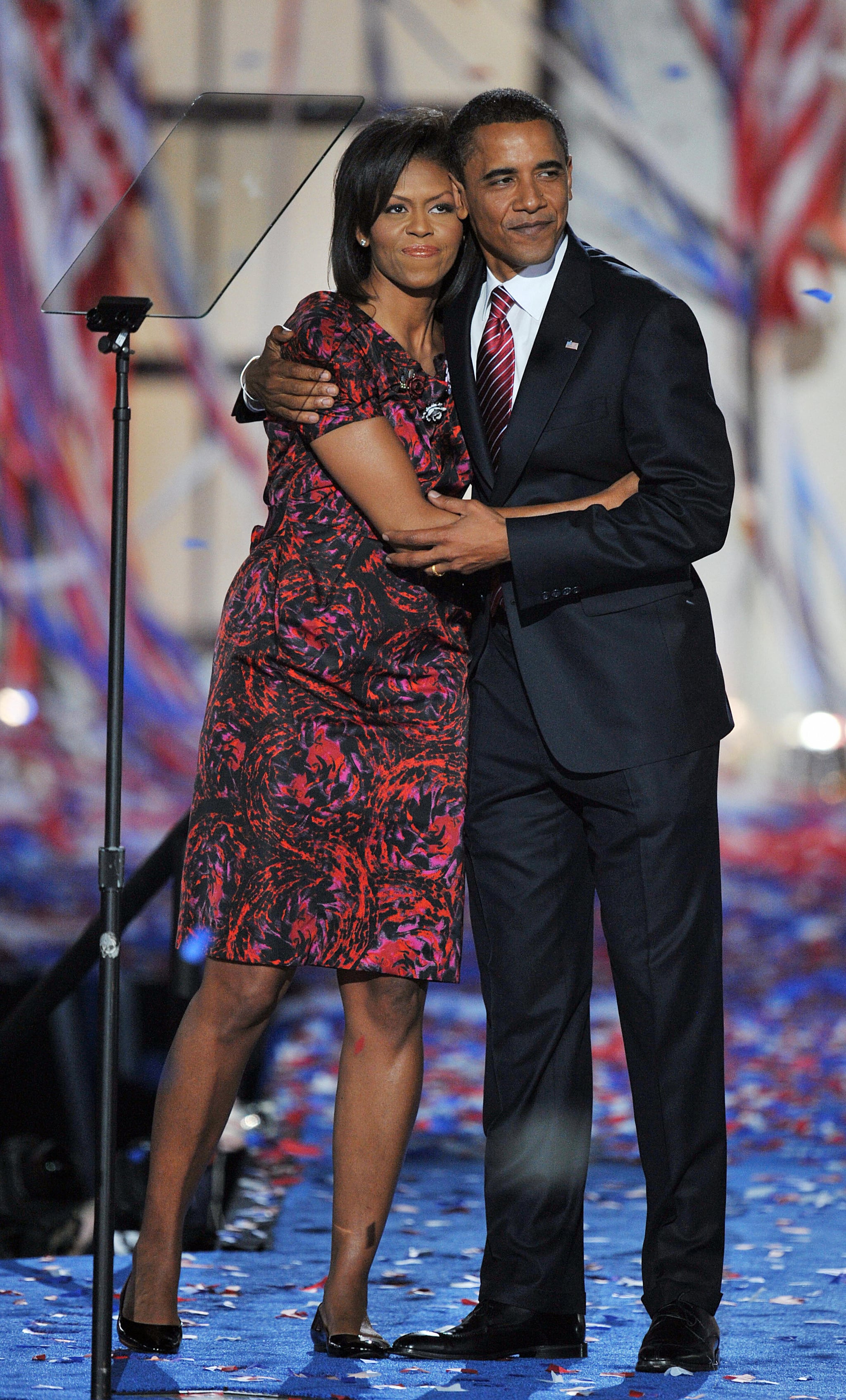 Democratic Presidential candidate Barack Obama hugs his wife Michelle on stage at the end of the Democratic National Convention 2008 at the Invesco Field in Denver, Colorado, on August 28, 2008. The Illinois senator tonight formally accepted his nomination as the first African-American from a major party to run for the White House before more than70,000 people. . AFP PHOTO Paul J. RICHARDS (Photo credit should read PAUL J. RICHARDS/AFP via Getty Images)