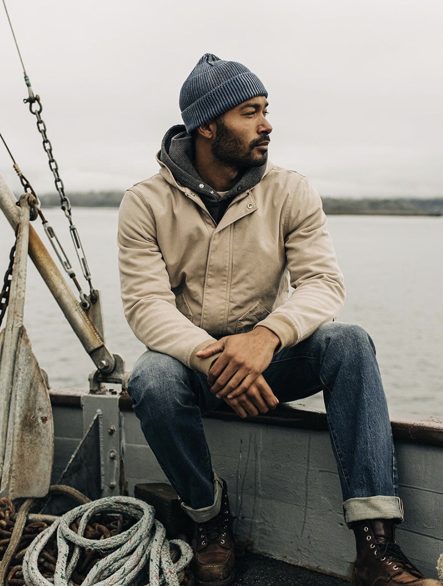model wearing work pants for men on a sail boat on a foggy day 
