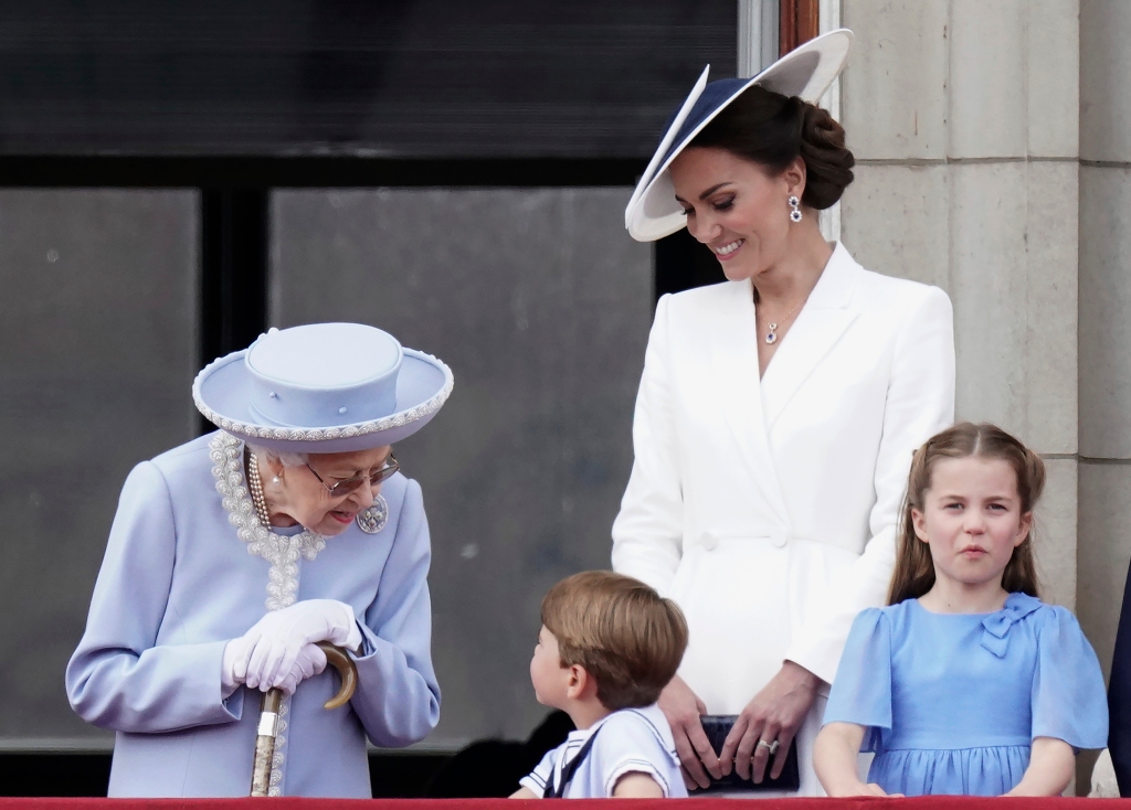 Queen Elizabeth II, Kate, Duchess of Cambridge, Prince Louis, Princess Charlotte watch from the balcony of Buckingham Place after the Trooping the Color ceremony in London, Thursday, June 2, 2022, on the first of four days of celebrations to mark the Platinum Jubilee. The events over a long holiday weekend in the U.K. are meant to celebrate the monarch's 70 years of service.(Aaron Chown/Pool Photo via AP)
