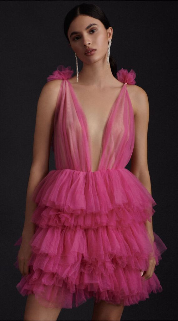 Go for bold and daring in Millia London’s bright pink tiered minidress with a plunging neckline and ruffled layers of tulle. $750 at BHLDN, 195 Broadway.