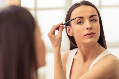 woman doing her eyebrows