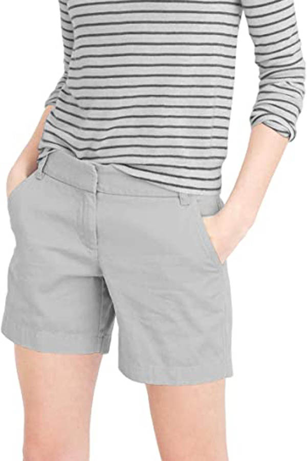 Close-up of model wearing grey chino shorts.
