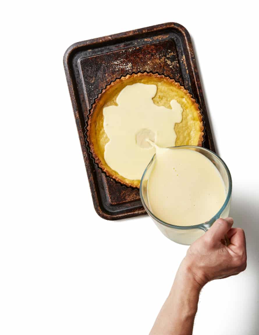 Put the tart shell on a baking sheet in the oven and, then, working quickly, pour the custard in