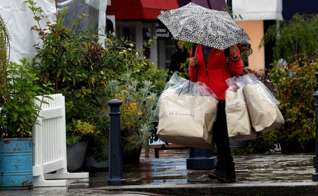 A shopper carries bags at Bicester Village, Oxfordshire.