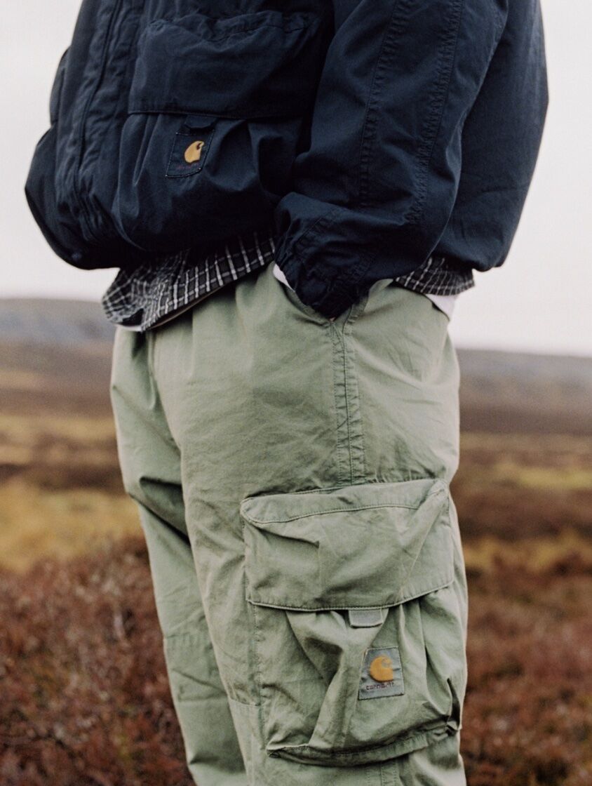 model wearing cargo pants and a puffer jacket, only mid-torso and upper legs is showing