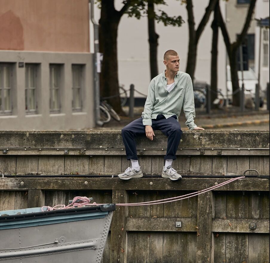 Man sitting on the side of dock 
