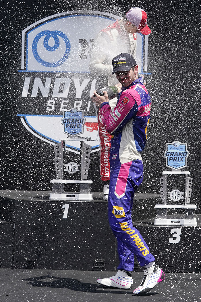 Alexander Rossi and Christian Lundgard, of Denmark, celebrate after the IndyCar auto race at Indianapolis Motor Speedway, Saturday, July 30, 2022, in Indianapolis. Rossi won the race and Lundgard finished second. (AP Photo/Darron Cummings)