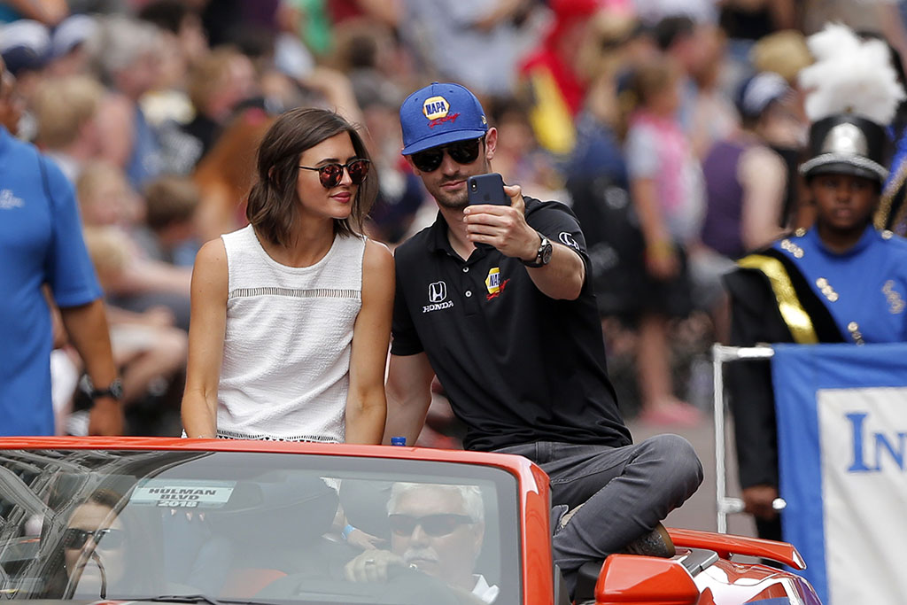 Indycar driver Alexander Rossi (27) of Andretti Autosport takes a selfie with his girlfriend Kelly Mossop during the 500 Festival Parade on May 26, 2018, in Indianapolis, Indiana. 