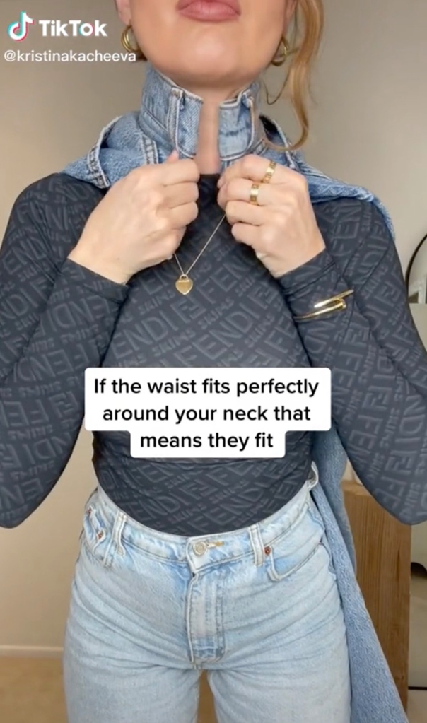 Woman trying to fit jeans around neck