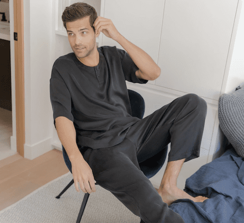 man wearing pajamas sitting on chair