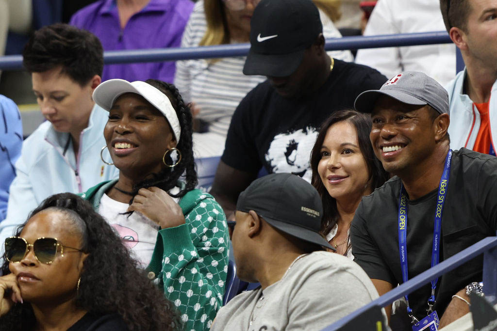 Erica Herman, Venus Williams, and Tiger Woods look on prior to a match at the 2022 US Open at USTA Billie Jean King National Tennis Center on August 31, 2022 in Queens, New York City. 