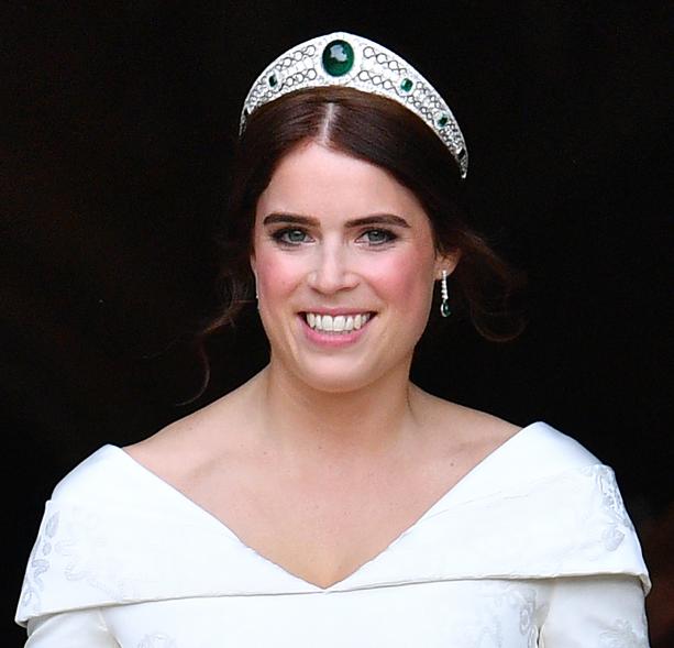 Princess Eugenie's look for her 2018 wedding broke with royal tradition: She displayed her scoliosis surgery scar in a custom gown and skipped the traditionally long veil. She did, however, wear the Greville Emerald Kokoshnik tiara, on loan from her grandmother, Queen Elizabeth II. The tiara was originally commissioned by Boucheron for English socialite Dame Margaret Greville, but before she died in 1942, she left all of her jewelry, including the tiara, to the Queen Mother, who later bequeathed it to her daughter, Queen Elizabeth II.