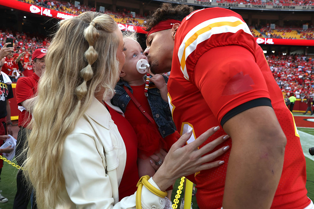 Patrick Mahomes #15 of the Kansas City Chiefs talks his wife, Brittany Matthews, and daughter, Sterling before the game against the Los Angeles Chargers at Arrowhead Stadium on September 15, 2022 in Kansas City, Missouri. 