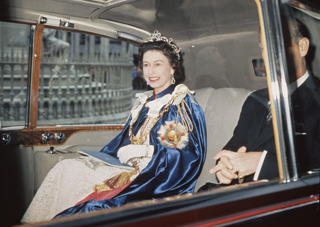 The Queen is pictured in 1968 dressed in a regal ensemble as she heads to an event in London with her husband, Philip. 