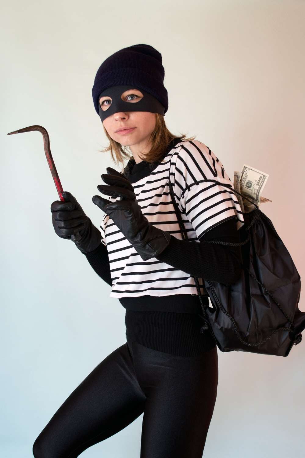 Woman dressed as a bank robber for Halloween. 