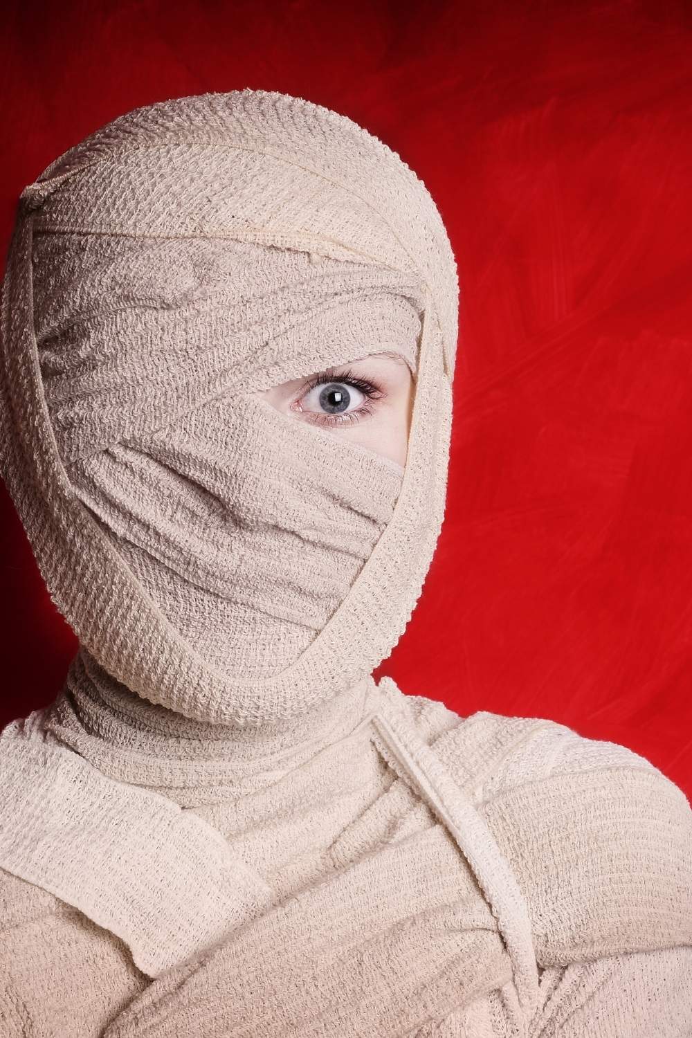 Close up of woman wrapped in bandages for a Halloween costume.