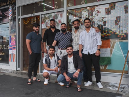Virinder Ghangas and friends pose for a photo outside his shop during Diwali festivities in Harris Park, 2022