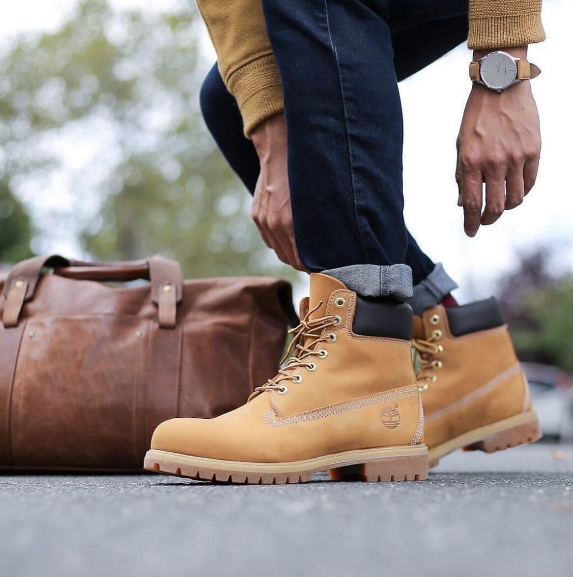 Man leaning down fixing Timberland boots
