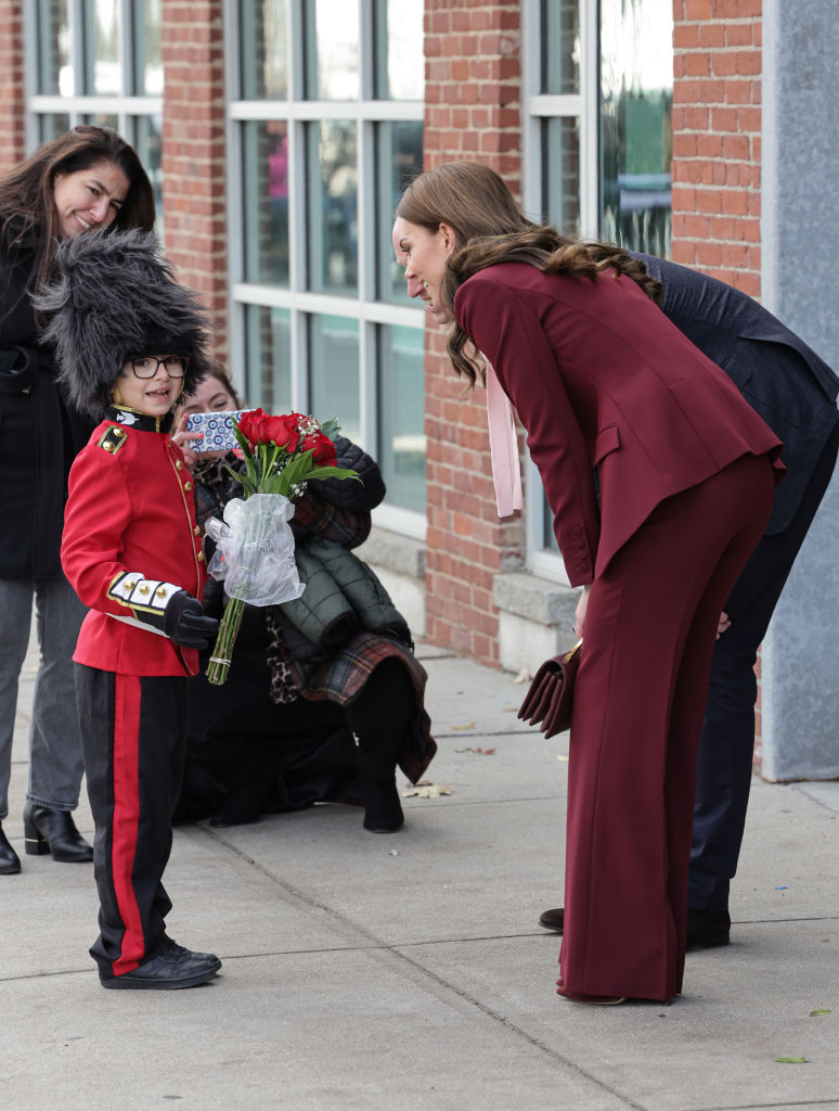 BOSTON, MASSACHUSETTS - DECEMBER 01: Prince William, Prince of Wales and Catherine, Princess of Wales receive flowers from Henry Dynov-Teixeira as they depart Greentown Labs, North America’s largest clean-tech incubator, where they learned more about how climate innovation is nurtured and scaled on December 01, 2022 in Boston, Massachusetts. The Prince and Princess of Wales are visiting the coastal city of Boston to attend the second annual Earthshot Prize Awards Ceremony, an event which celebrates those whose work is helping to repair the planet. During their trip, which will last for three days, the royal couple will learn about the environmental challenges Boston faces as well as meeting those who are combating the effects of climate change in the area. (Photo by Chris Jackson/Getty Images)