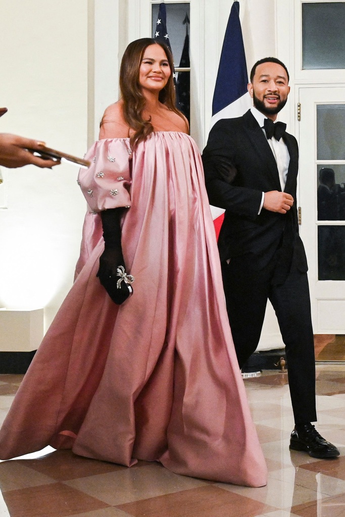 US singer-songwriter John Legend and his wife model Chrissy Teigen arrive at the White House to attend a state dinner honoring French President Emmanuel Macron, in Washington, DC, on December 1, 2022. (Photo by ROBERTO SCHMIDT / AFP) (Photo by ROBERTO SCHMIDT/AFP via Getty Images)