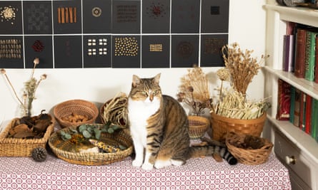 Mathilda’s cat poses in front of her artwork.