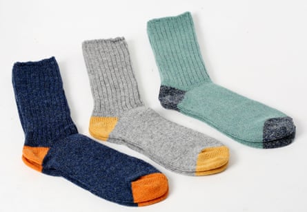 Three pairs of socks, lined up on a white surface.