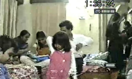 a shot of family gathered, with an old video timestamp at the top right