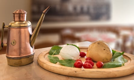 dough, basil, tomato and mozzarella on a board with olive oil jug