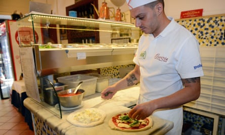 Pizzaiolo at the counter inside Pizzeria Gorizia 