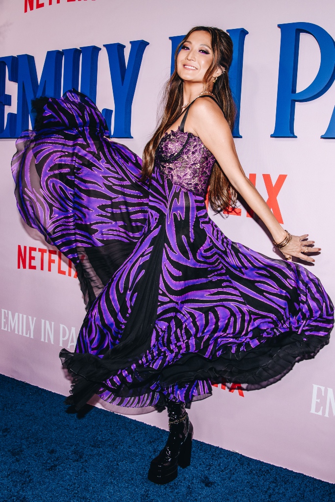 ashley park, purple dress, corset, valentino, platform boot, black leather boot, emily in paris, premiere, red carpet, nyc, lily collins, white bow dress