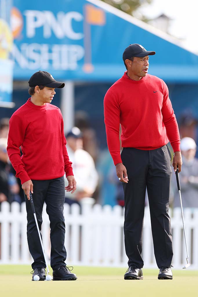 ORLANDO, FLORIDA - DECEMBER 18: Charlie Woods and Tiger Woods of the United States looks on from the practice green during the final round of the PNC Championship at Ritz-Carlton Golf Club on December 18, 2022 in Orlando, Florida. (Photo by Mike Ehrmann/Getty Images)
