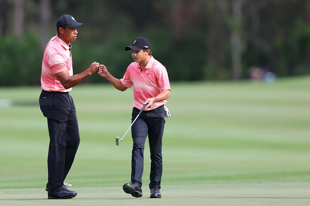 ORLANDO, FLORIDA - DECEMBER 17: Tiger Woods of the United States and son Charlie Woods celebrate on the sixth green during the first round of the PNC Championship at Ritz-Carlton Golf Club on December 17, 2022 in Orlando, Florida. (Photo by Mike Ehrmann/Getty Images)