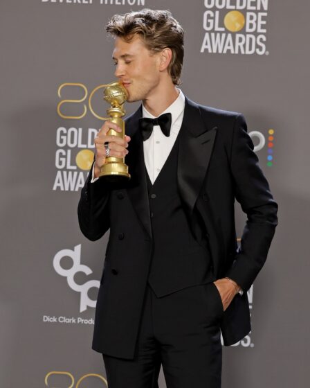 Austin Butler poses with his Golden Globe award for best actor in a motion picture drama.