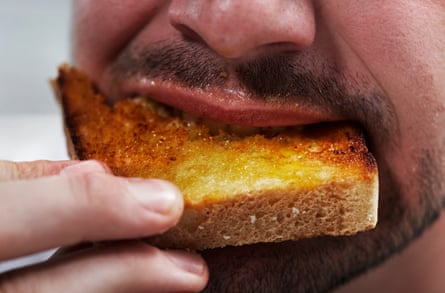 Close-up of man eating toast