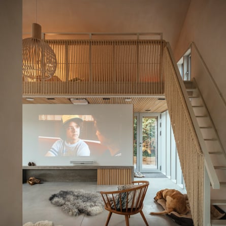 Movie night: the sisal balustrade and drop-down concealed projector screen over the fireplace.