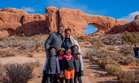 family poses in front of rock formation