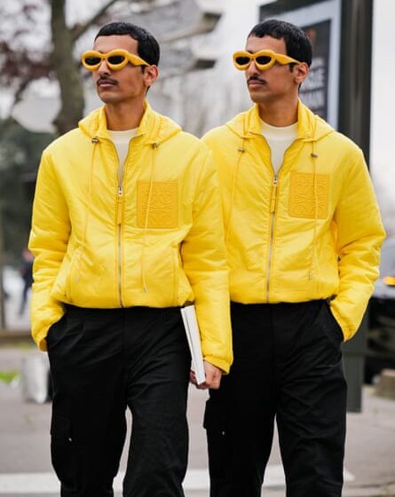 two men in bright yellow jackets and sunglasses with bright orange frames