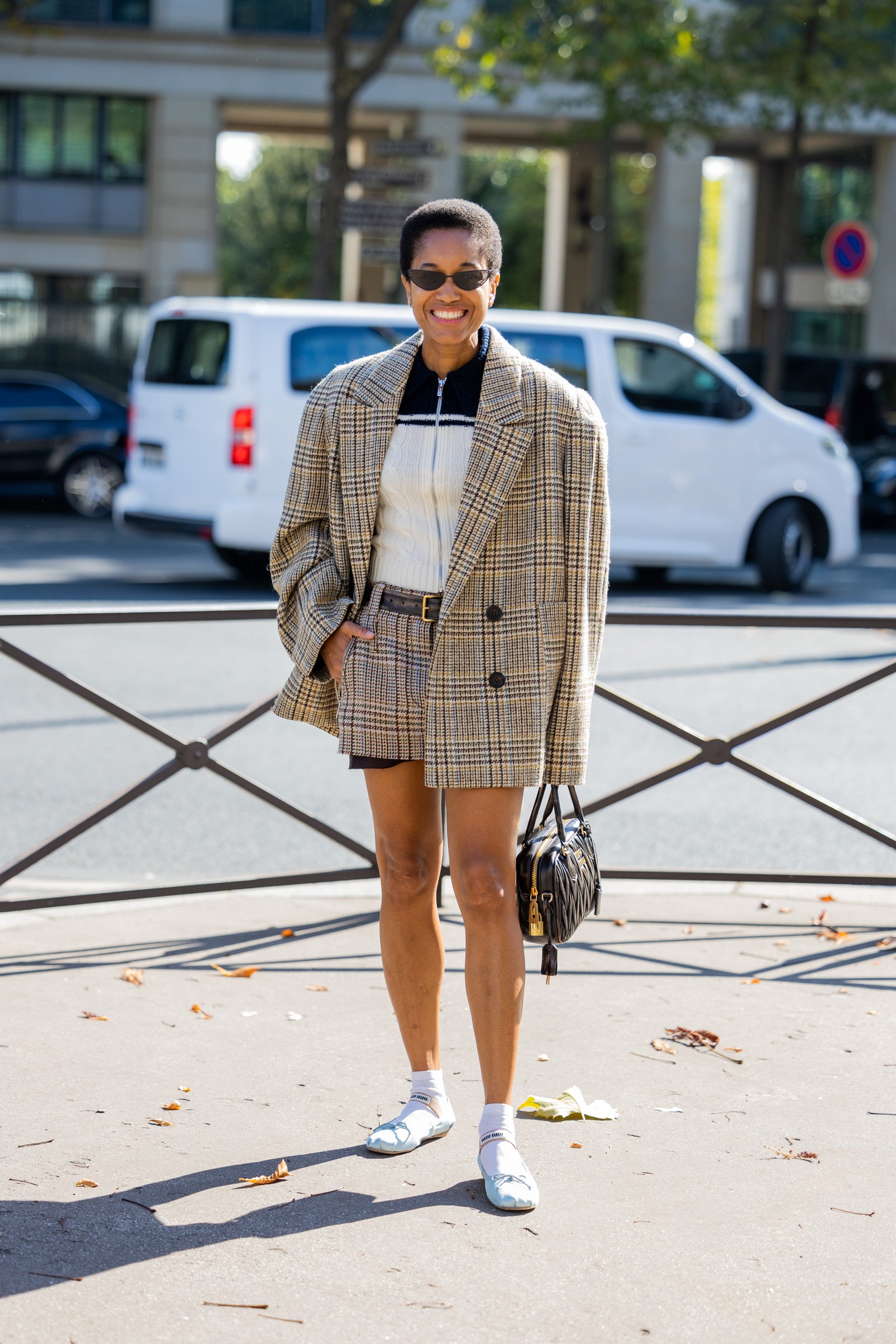 PARIS FRANCE  OCTOBER 04 Tamu McPherson wears oversized beige blazer shorts black bag outside Miu Miu during Paris...