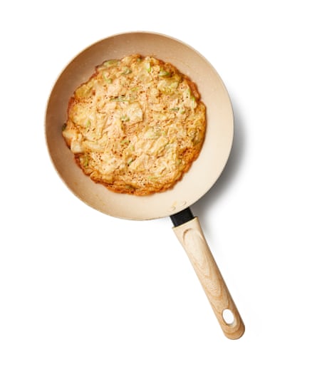 Put two tablespoons of oil in a large, nonstick frying pan on a medium-high heat and wait until it shimmers. Spoon in half or all of the batter, depending on whether you’re making one large or two small pancakes, and flatten into a thin round. Move the pancake around by shaking the pan as soon as you’re able to, to help spread the oil underneath and stop the pancake sticking, then leave to cook for about five minutes, until the edges are golden brown and the top is matt (go by the look of it).