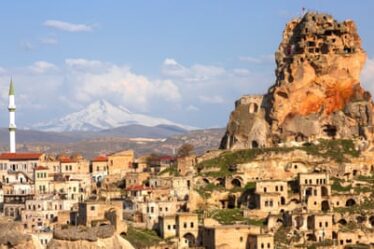 Ortahisar in Cappadocia with the inactive volcano Erciyes in the background.