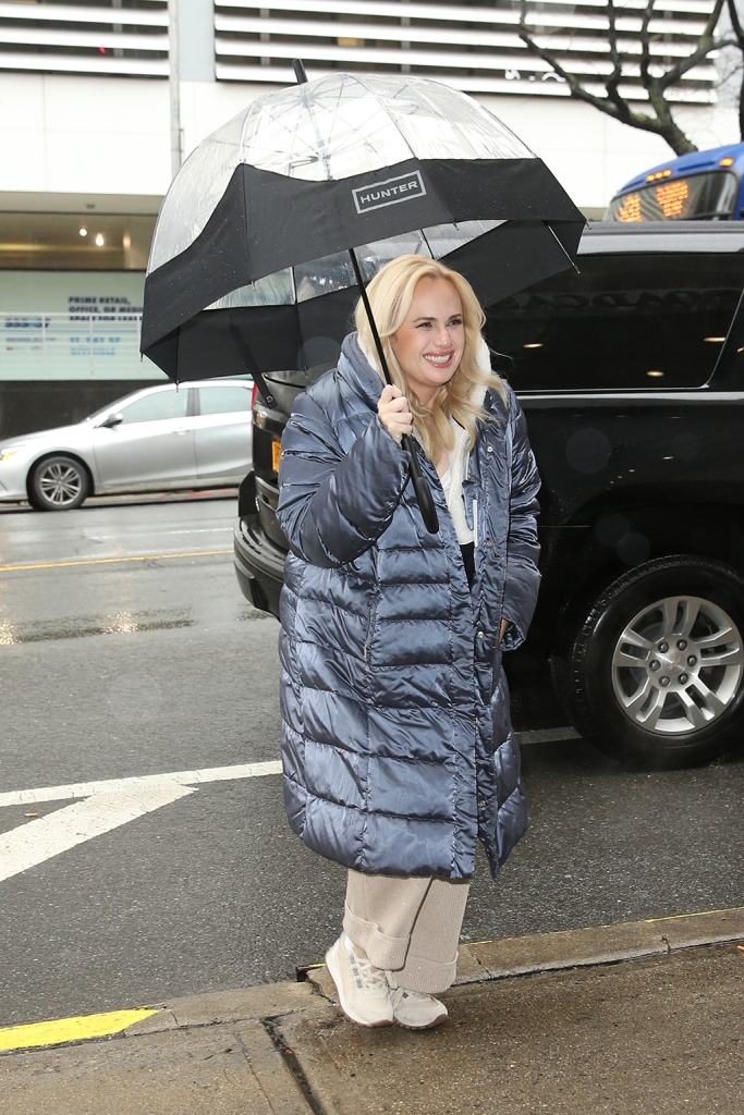 Rebel Wilson suffers an umbrella malfunction outside CBS Studios in New York on Feb. 27, 2023.