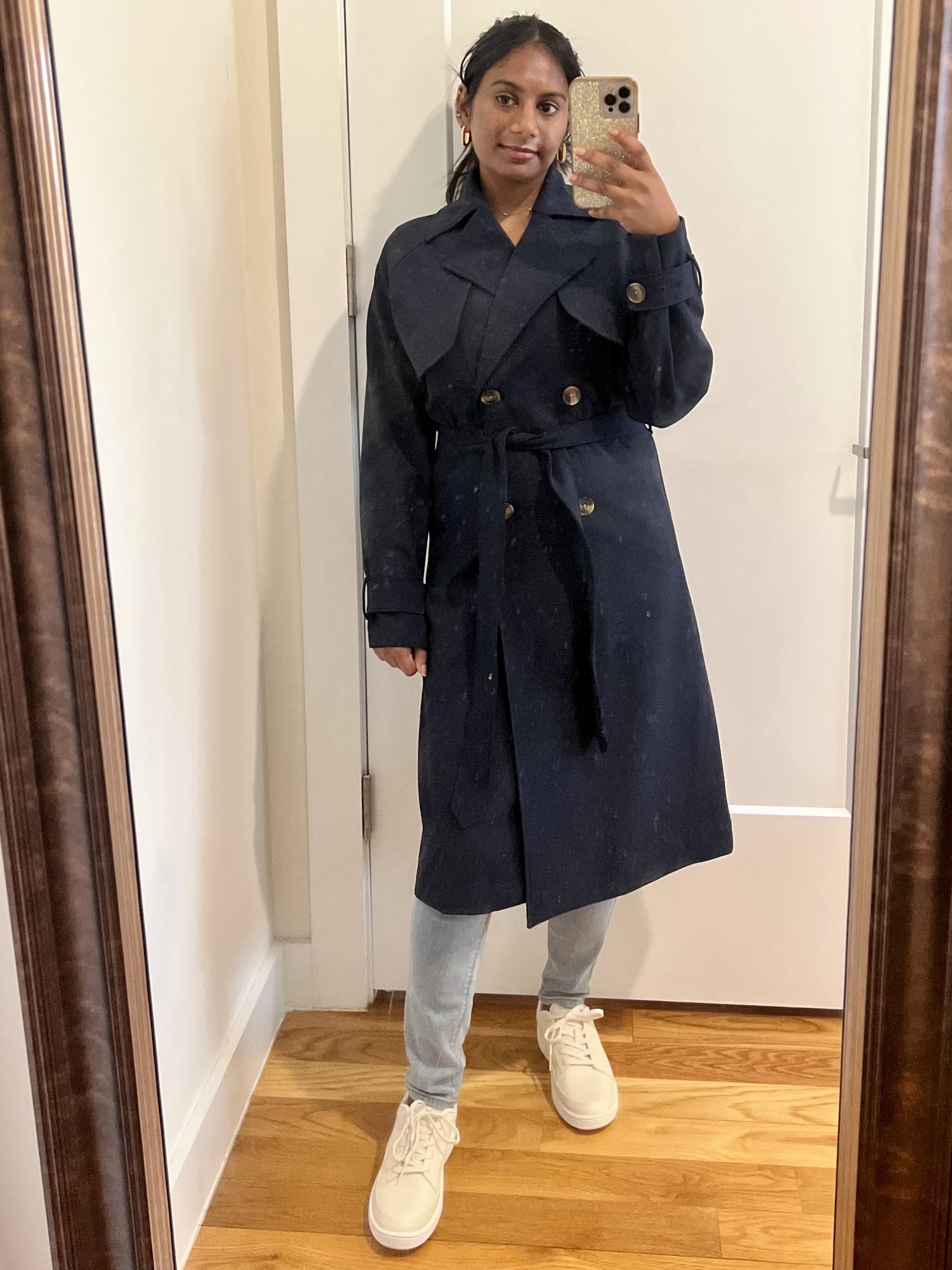 Woman wearing the Old Navy Double-Breasted Tie-Belt Trench Coat in navy buttoned and tied.